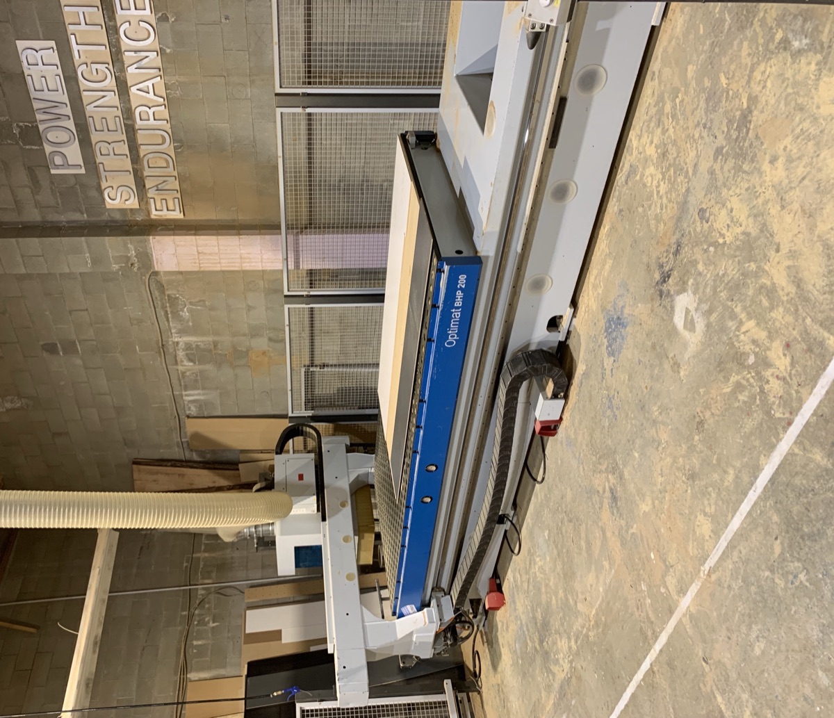 CNC precision cutting machine at work on wood panel